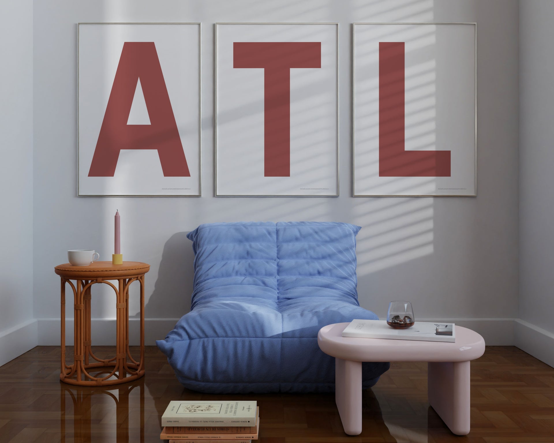 Three large framed Nantucked red and white letter art prints spelling out ATL hanging above a blue chair.