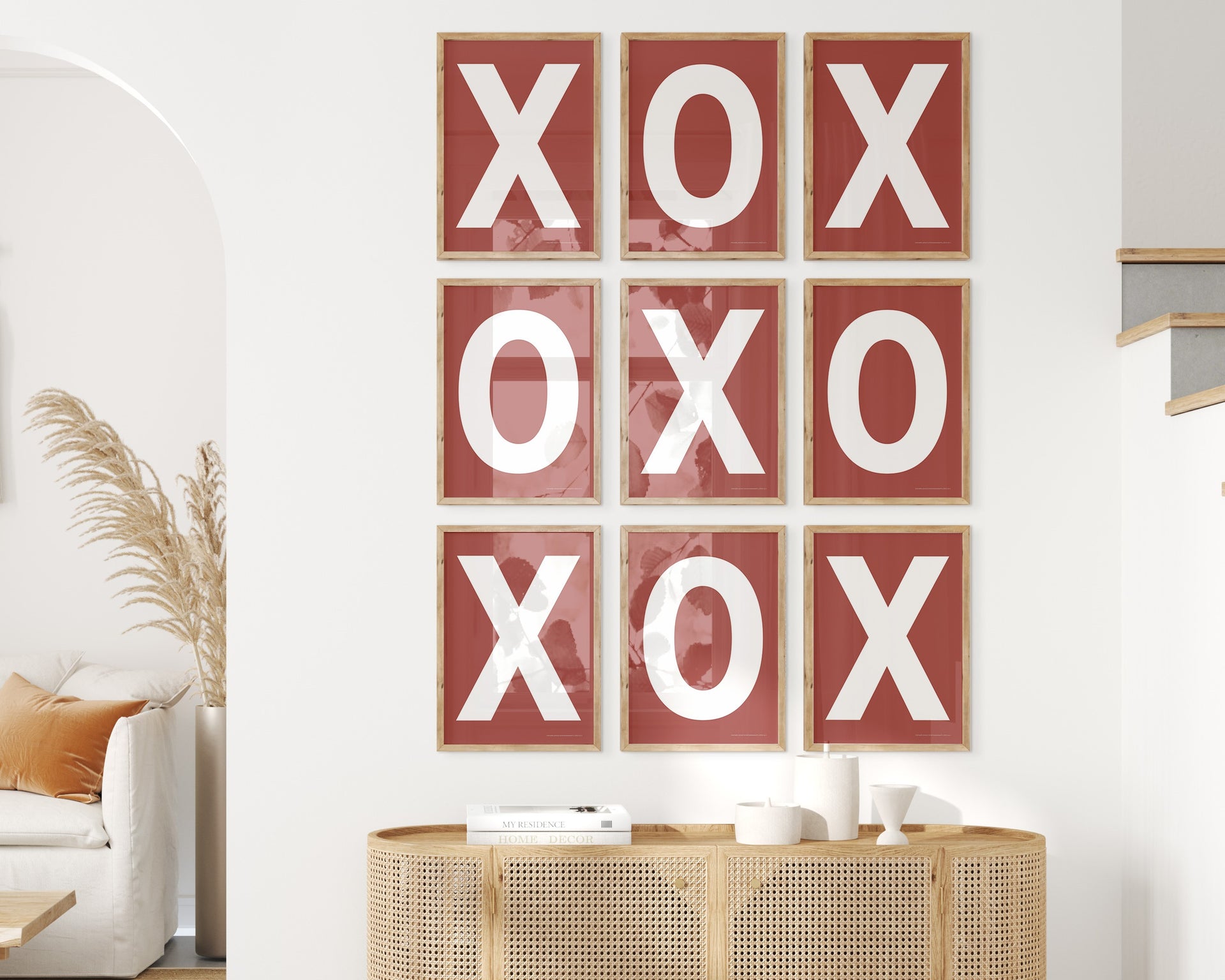 Nine framed white and Nantucket red letter art prints featuring X and O creating tic tac toe on the wall.