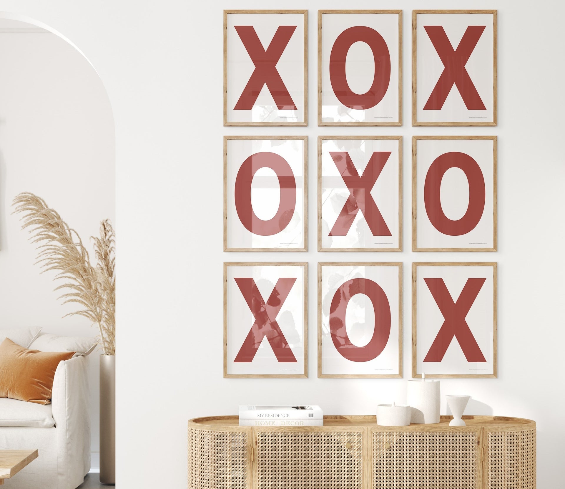 Nine framed white and Nantucket red letter art prints featuring X and O creating tic tac toe on the wall.