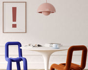 Framed Nantucket red and white exclamation point hanging on a wall in a modern dining room.