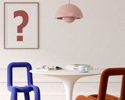 Framed Nantucket red and white exclamation point haning on a wall in a modern dining room.