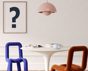 Framed navy blue and white exclamation point haning on a wall in a modern dining room.