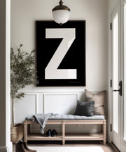 Oversized framed black and white letter art print in a farmhouse entryway.