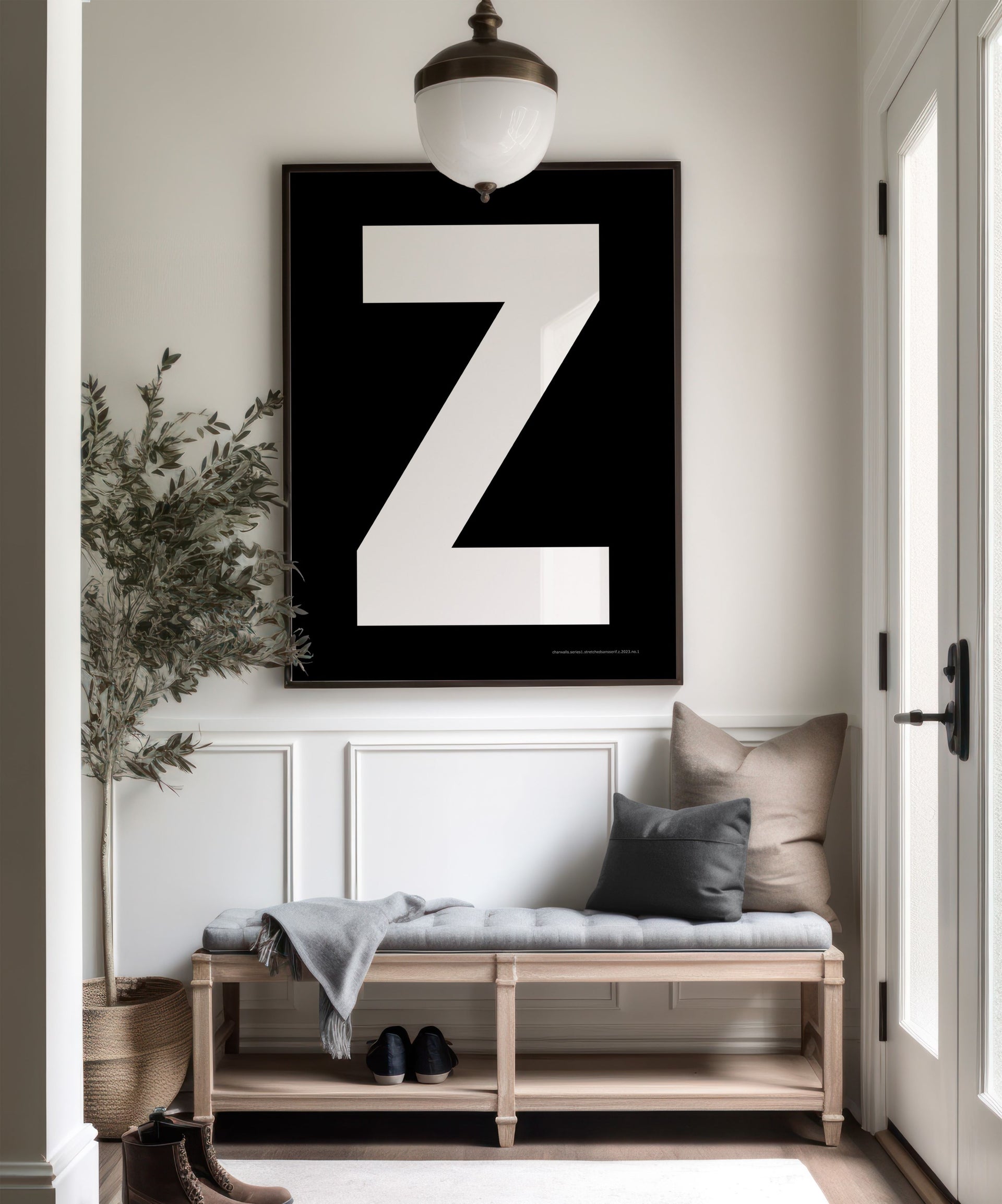 Oversized framed black and white letter art print in a farmhouse entryway.