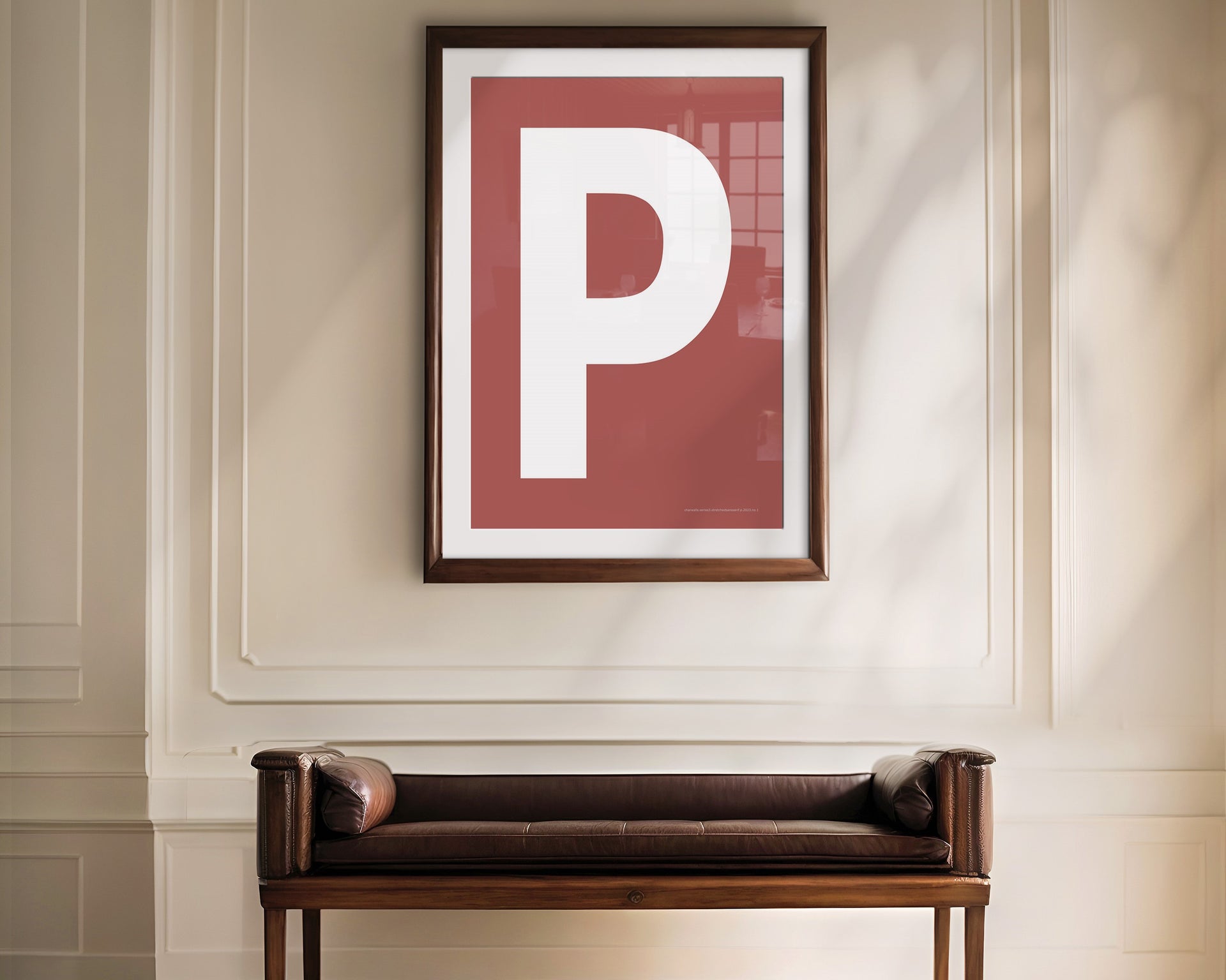 Oversized framed Nantucket red and white letter art print haning above a bence in a formal entryway or hallway.