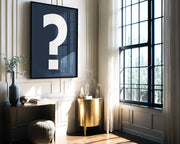 Oversized framed navy blue and white question mark hanging in formal living room.