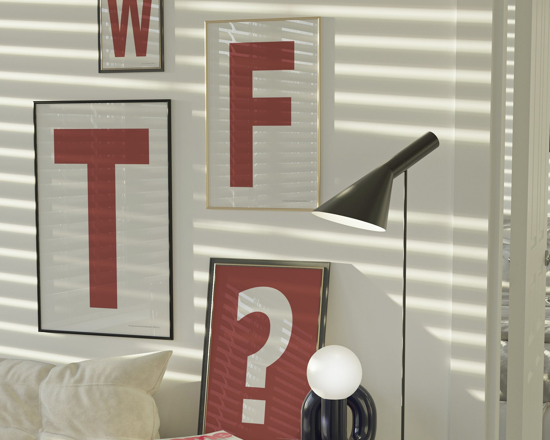 Four framed Nantucket red and white letter and question mark art prints spelling out WTF? hanging on the wall in a modern living room.
