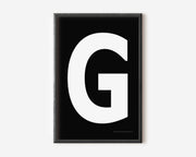 Modern art print with an uppercase white letter G on a black background.