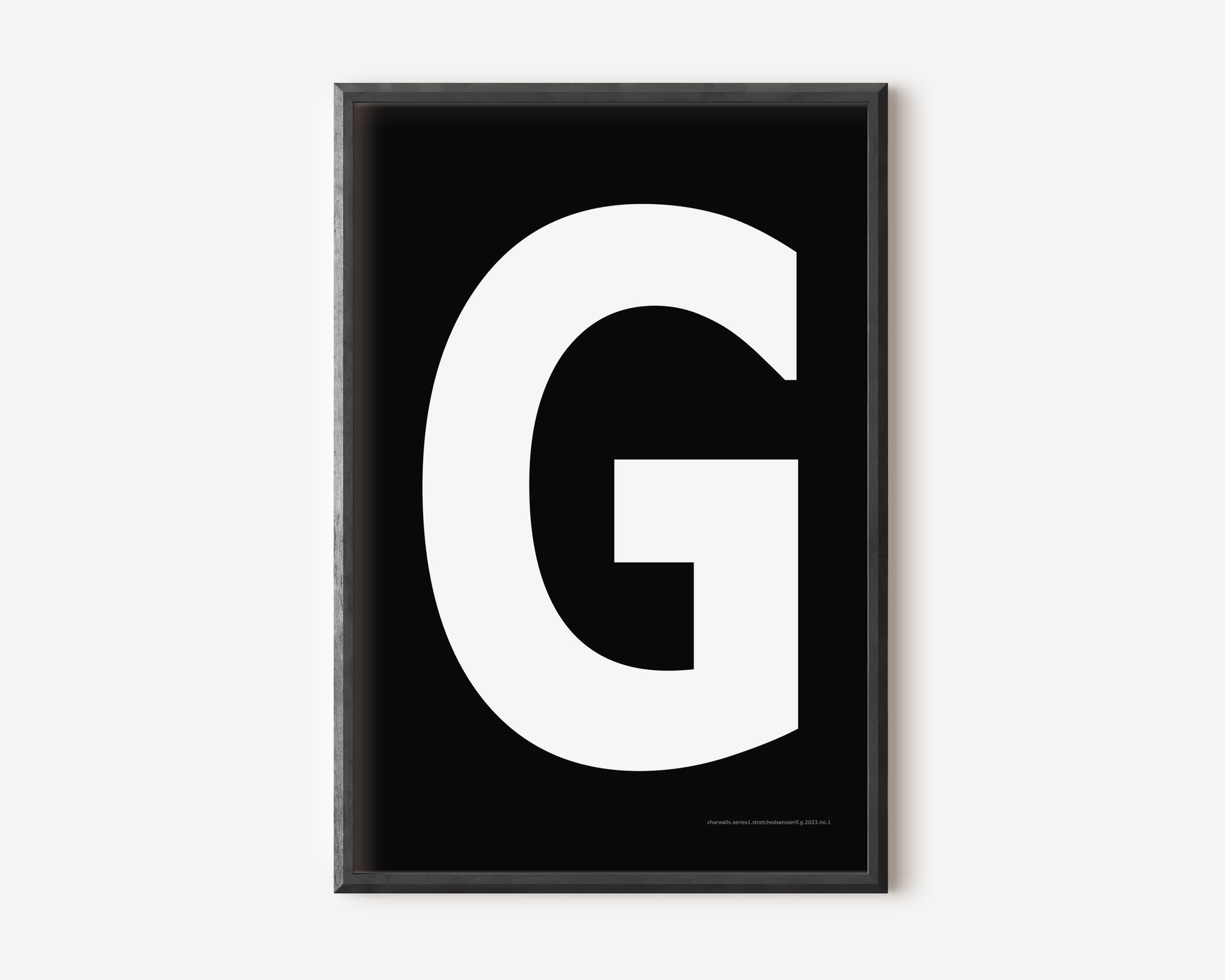Modern art print with an uppercase white letter G on a black background.