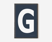 Modern art print with an uppercase white letter G on a navy blue background.