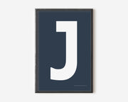 Modern art print with an uppercase white letter J on a navy blue background.
