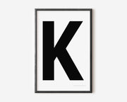 Modern art print with an uppercase black letter K on a white background.