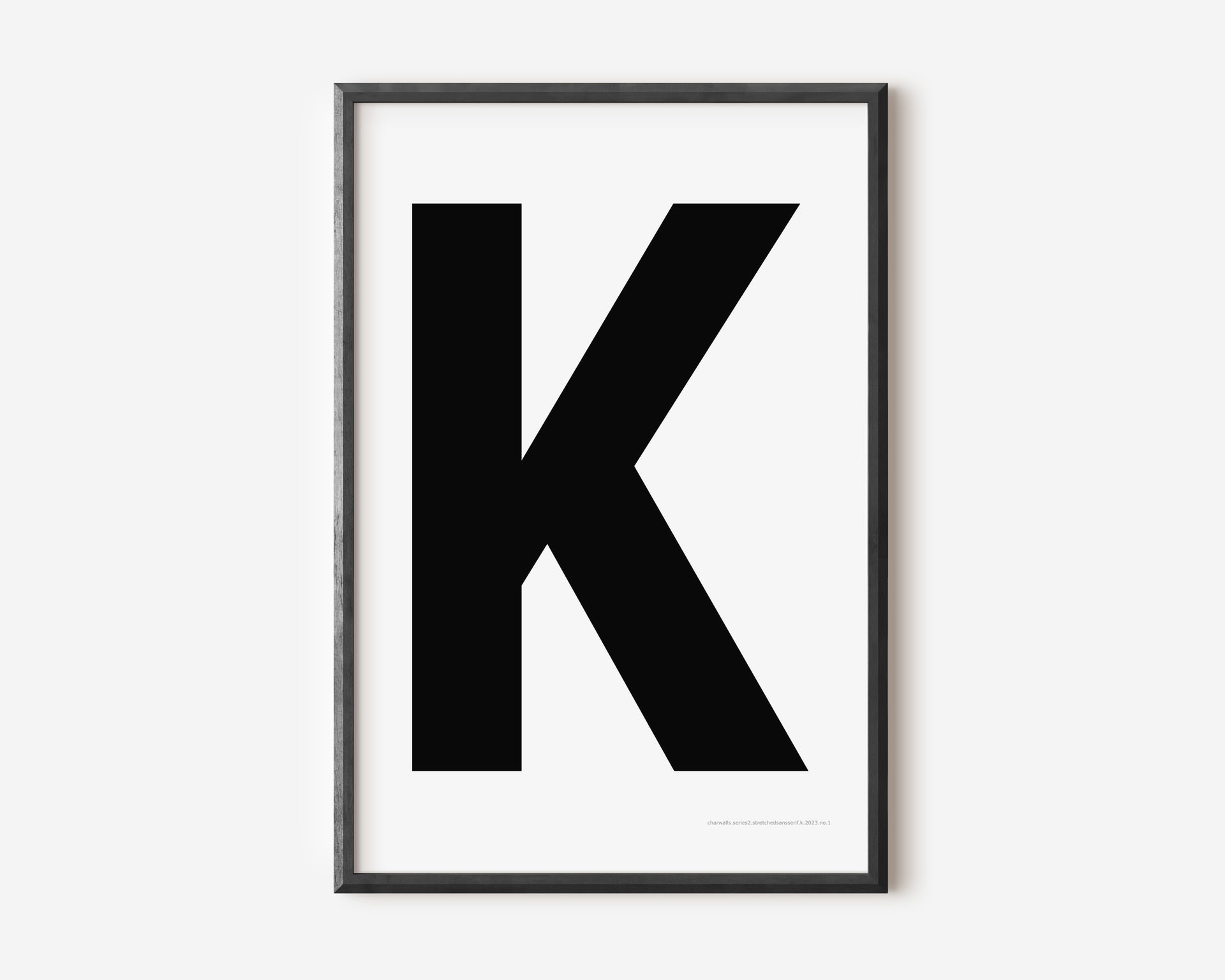 Modern art print with an uppercase black letter K on a white background.