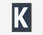 Modern art print with an uppercase white letter K on a navy blue background.