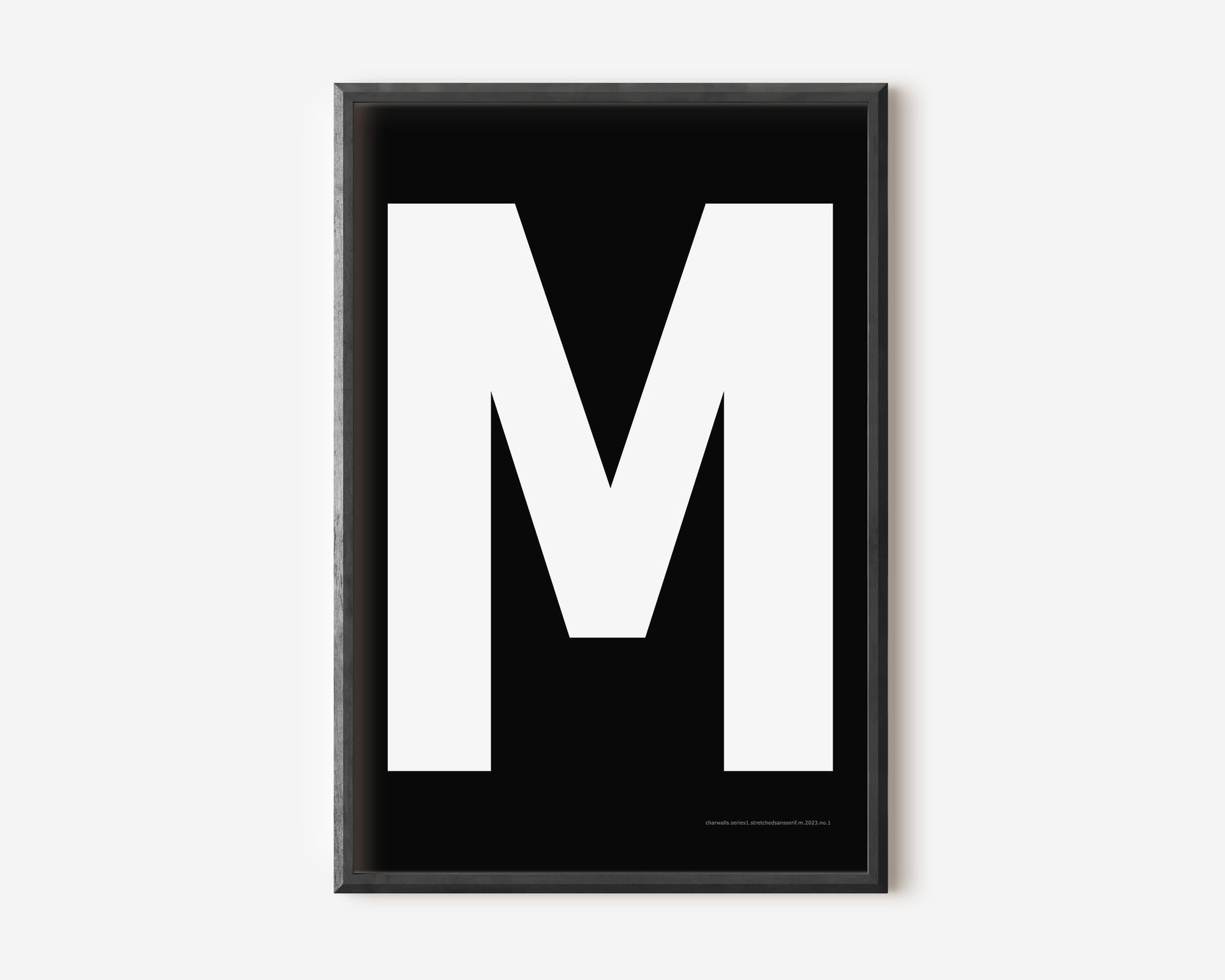 Modern art print with an uppercase white letter M on a black background.