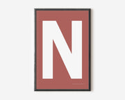 Modern art print with an uppercase white letter N on a Nantucket red background.