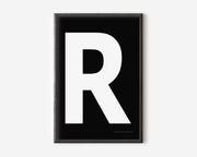 Modern art print with an uppercase white letter R on a black background.
