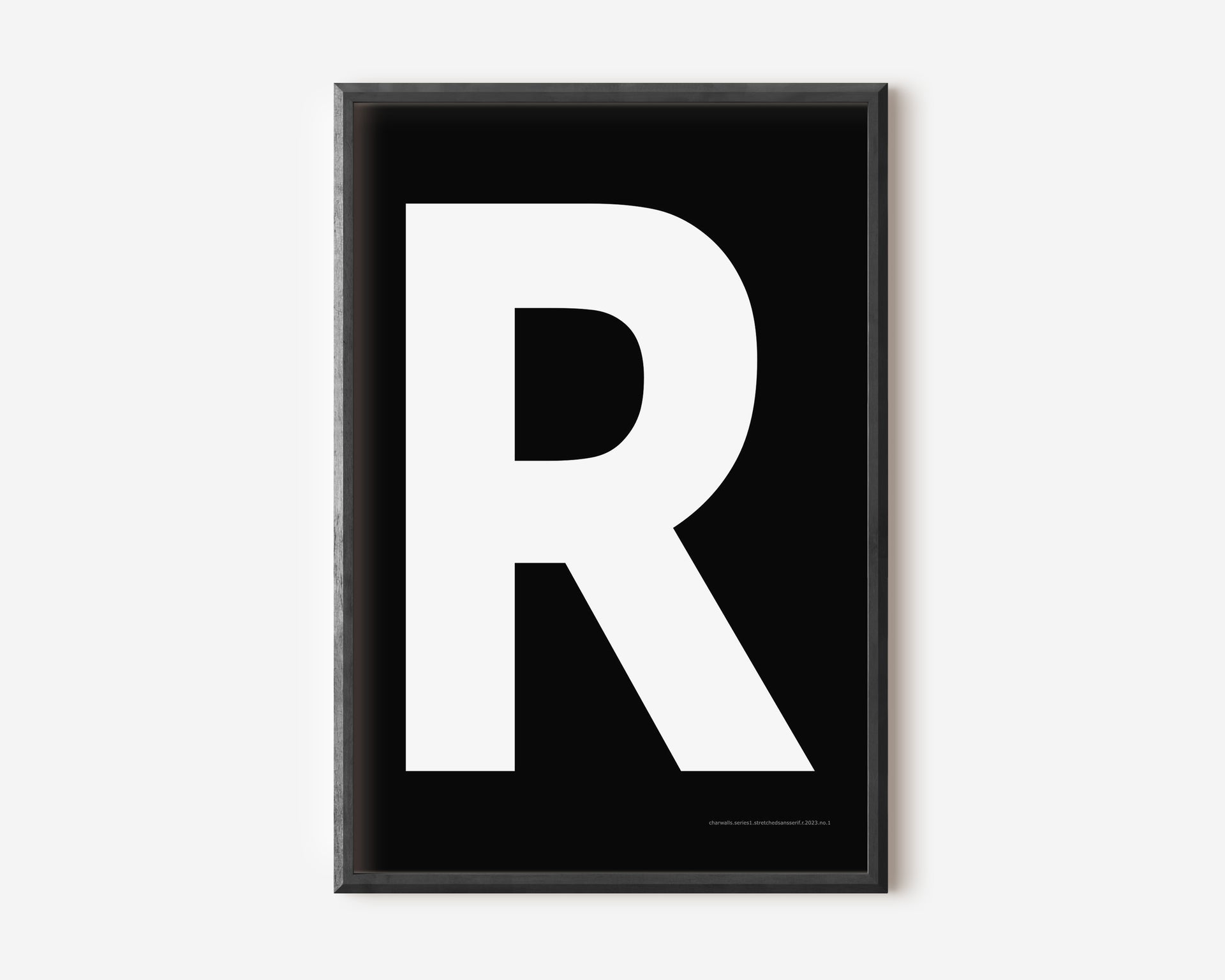 Modern art print with an uppercase white letter R on a black background.