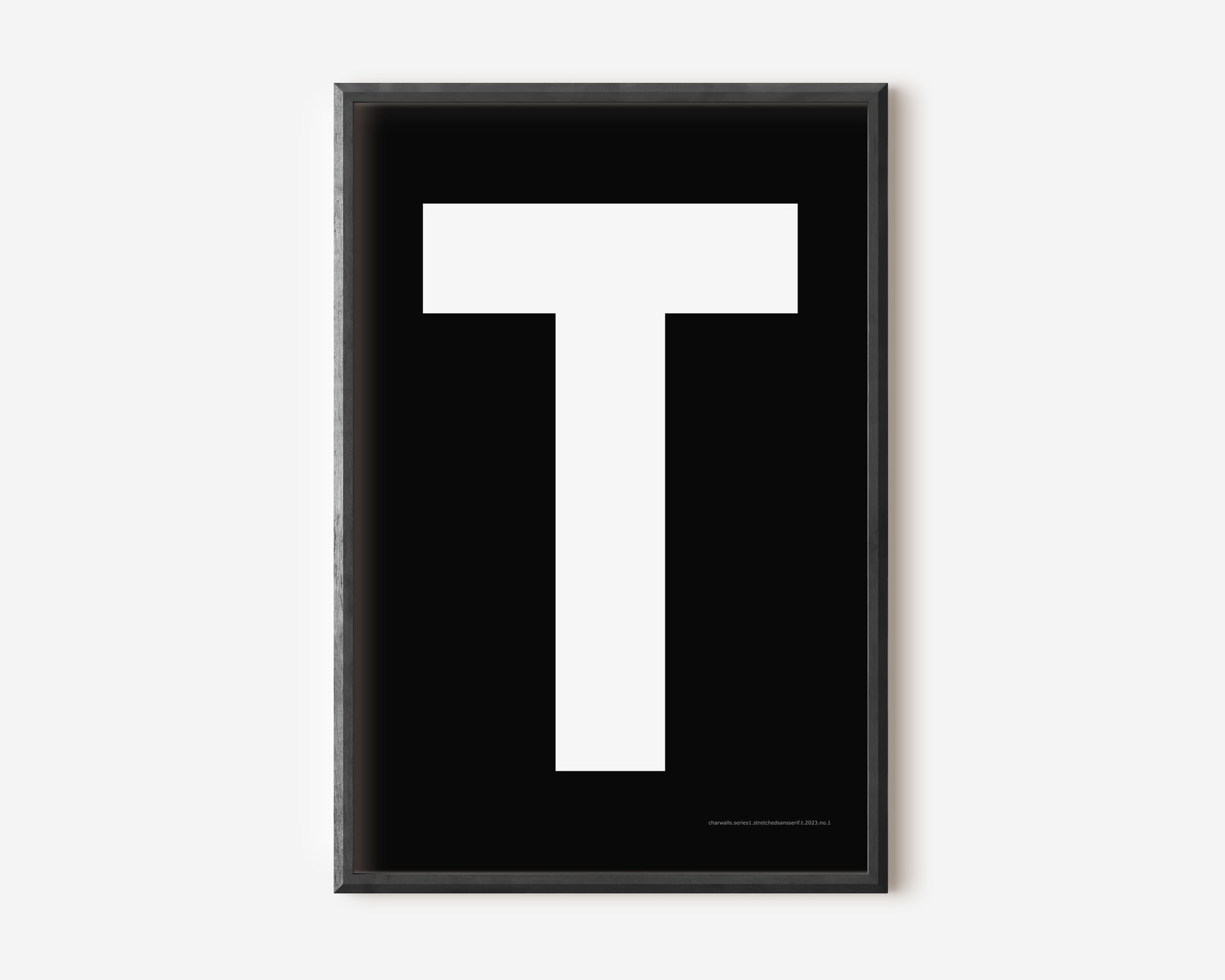 Modern art print with an uppercase white letter T on a black background.