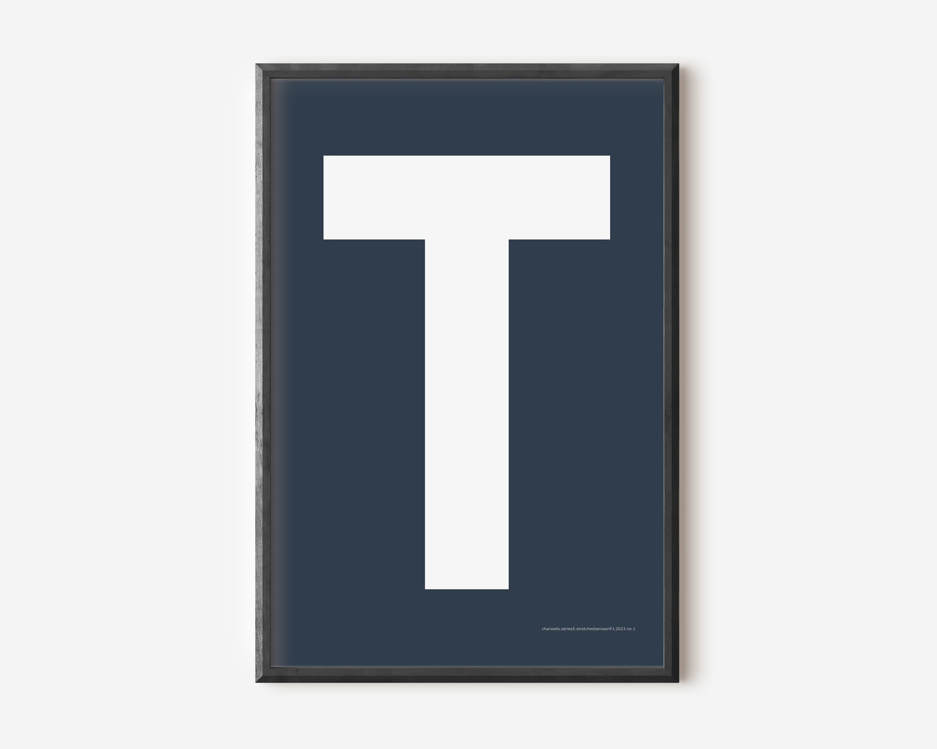 Modern art print with an uppercase white letter T on a navy blue background.