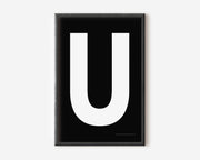 Modern art print with an uppercase white letter U on a black background.