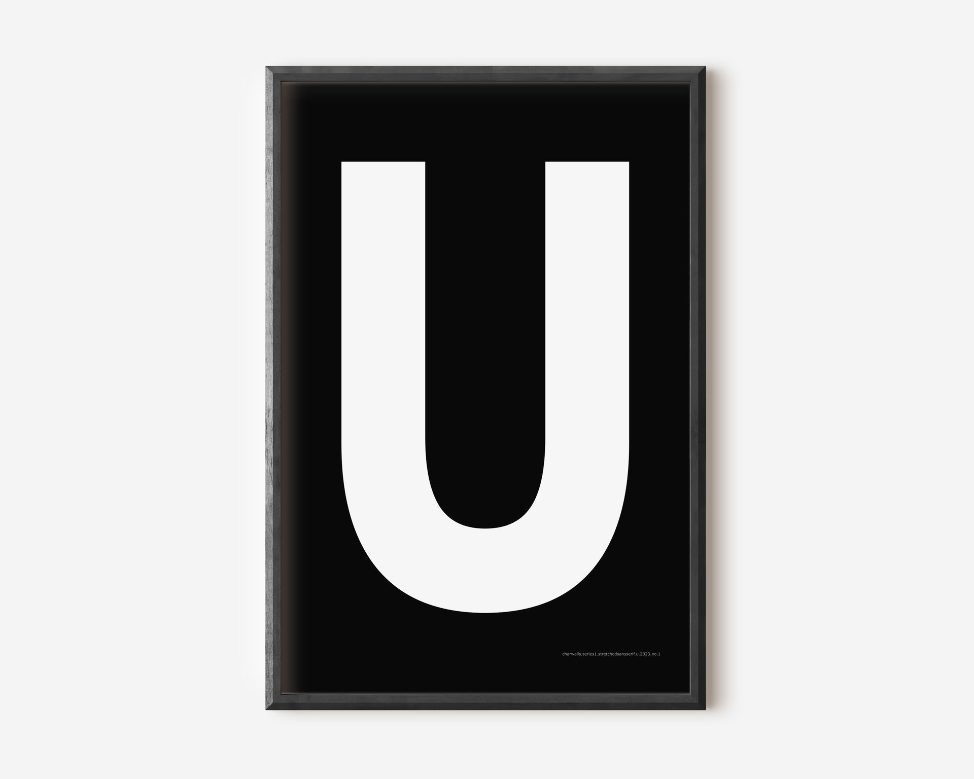 Modern art print with an uppercase white letter U on a black background.