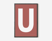 Modern art print with an uppercase white letter U on a Nantucket red background.