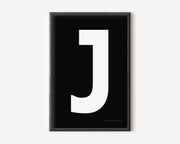Modern art print with an uppercase white letter J on a black background.
