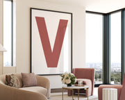 Oversized framed Nantucket red and white letter V art print hanging in a modern living room.