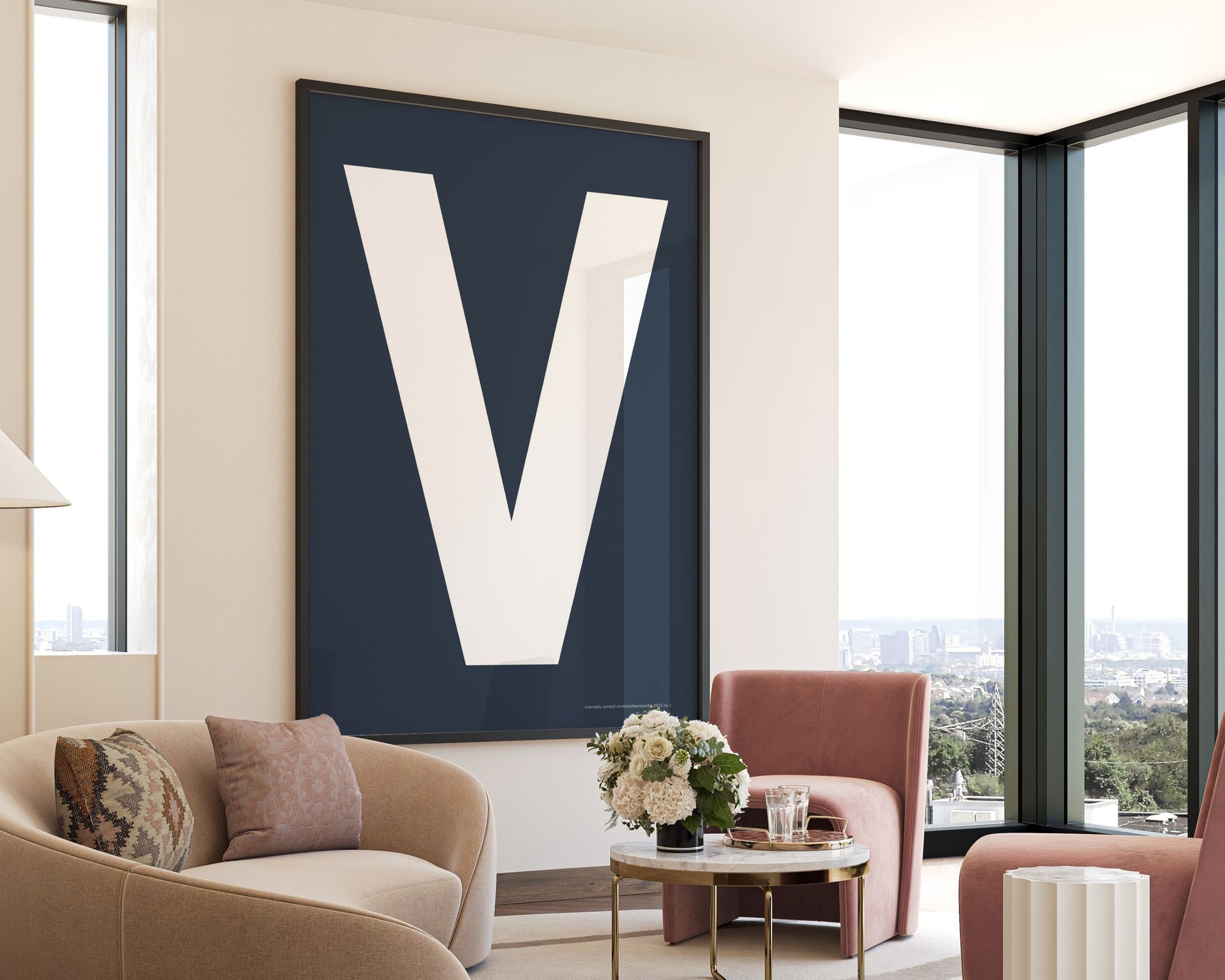Oversized framed navy blue and white letter V art print hanging in a modern living room.