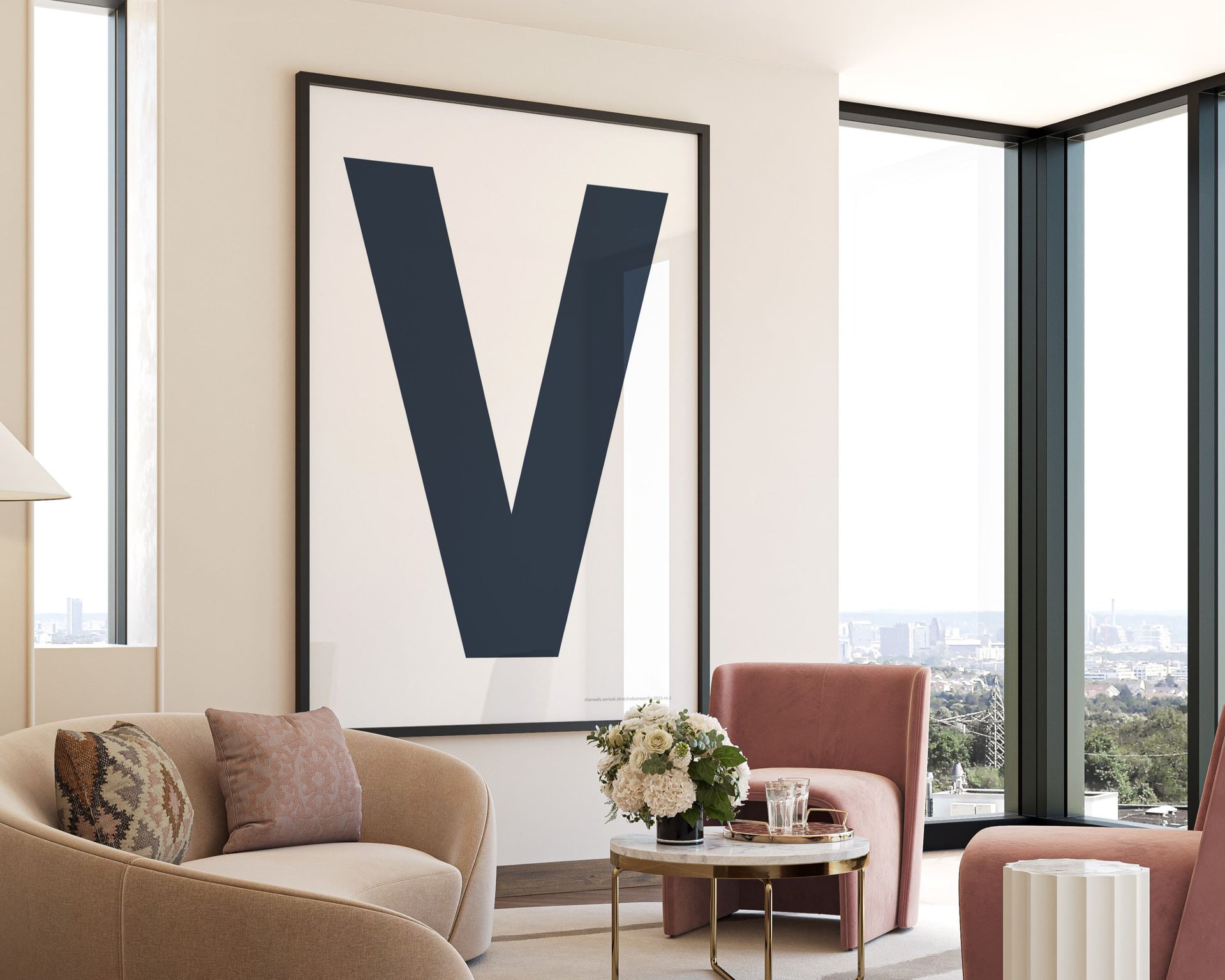 Oversized framed navy blue and white letter V art print hanging in a modern living room.