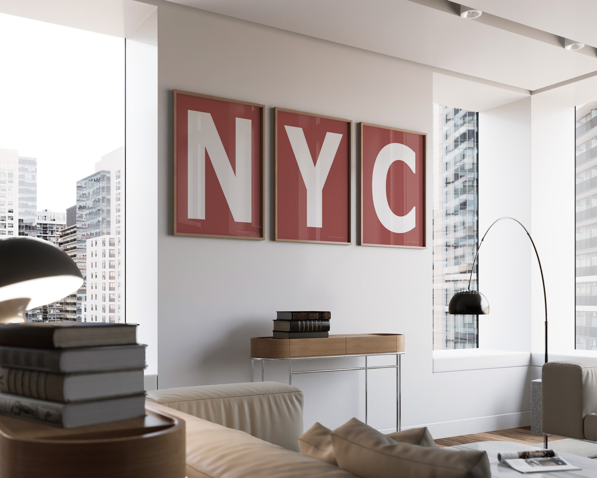 Three framed Nantucket red and white letter art prints spelling out NYC hanging on a wall in a modern living room with a view of the city.