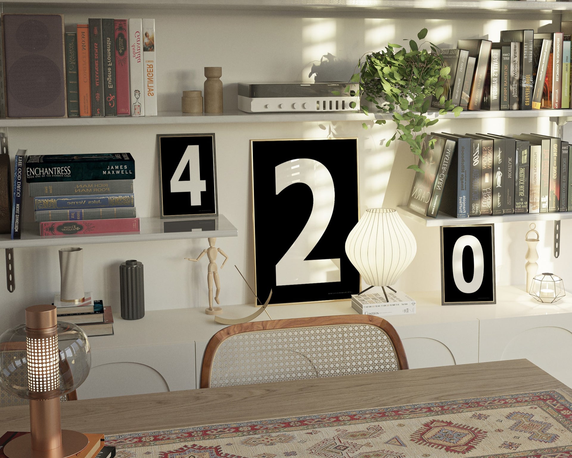 Three black and white framed number art prints spelling out 420 on an eclectic and modern bookshelf.