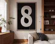 Oversized framed black and white number art print featuring the number 8 in a modern living room.