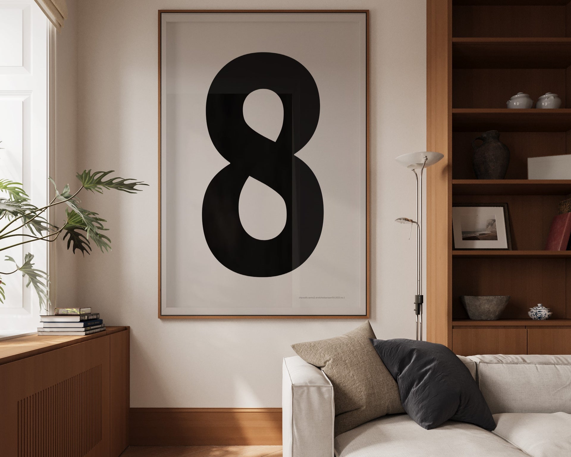 Oversized framed black and white number art print featuring the number 8 in a modern living room.
