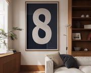 Oversized framed navy blue and white number art print featuring the number 8 in a modern living room.