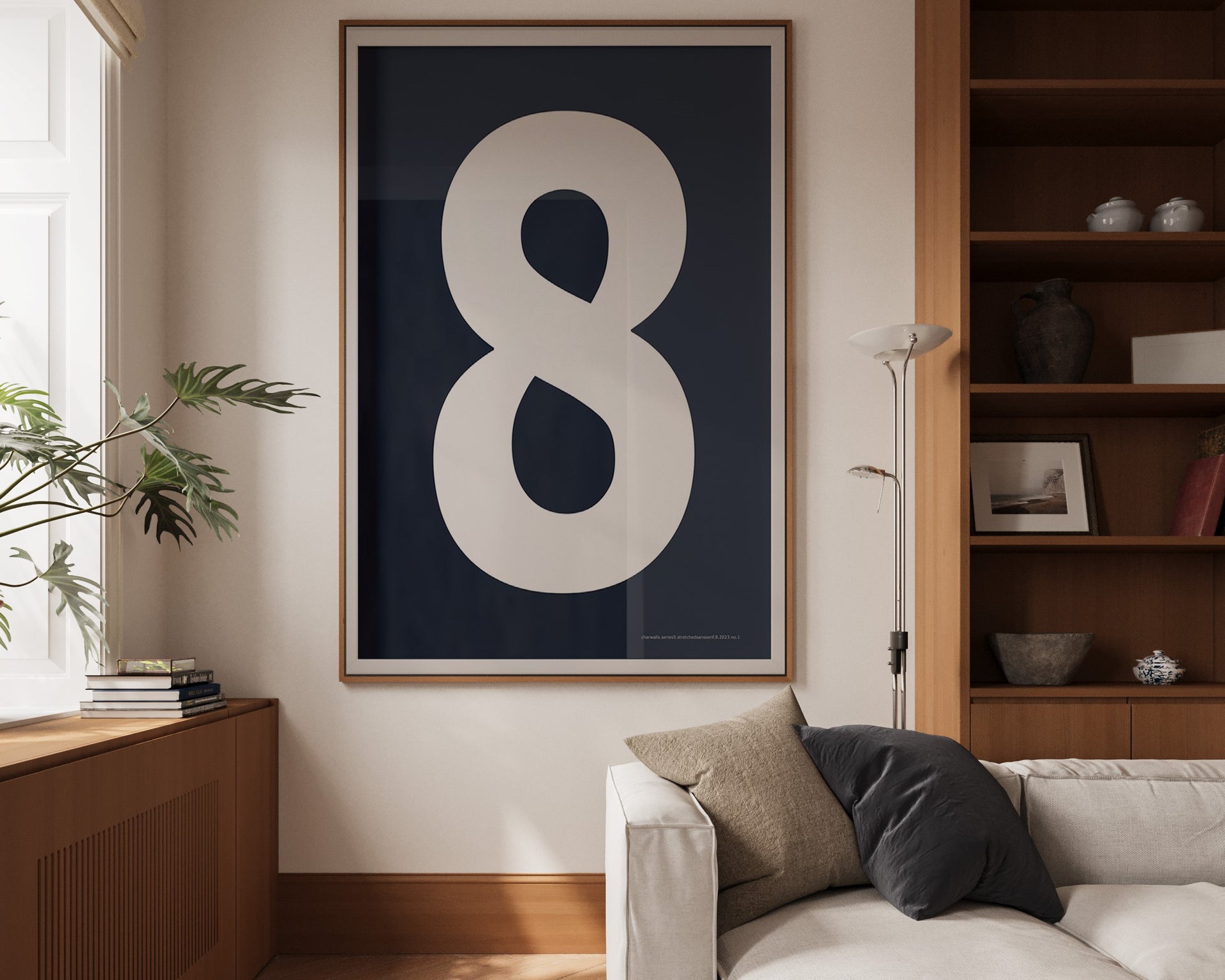 Oversized framed navy blue and white number art print featuring the number 8 in a modern living room.