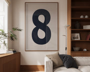Oversized framed navy blue and white number art print featuring the number 8 in a modern living room.