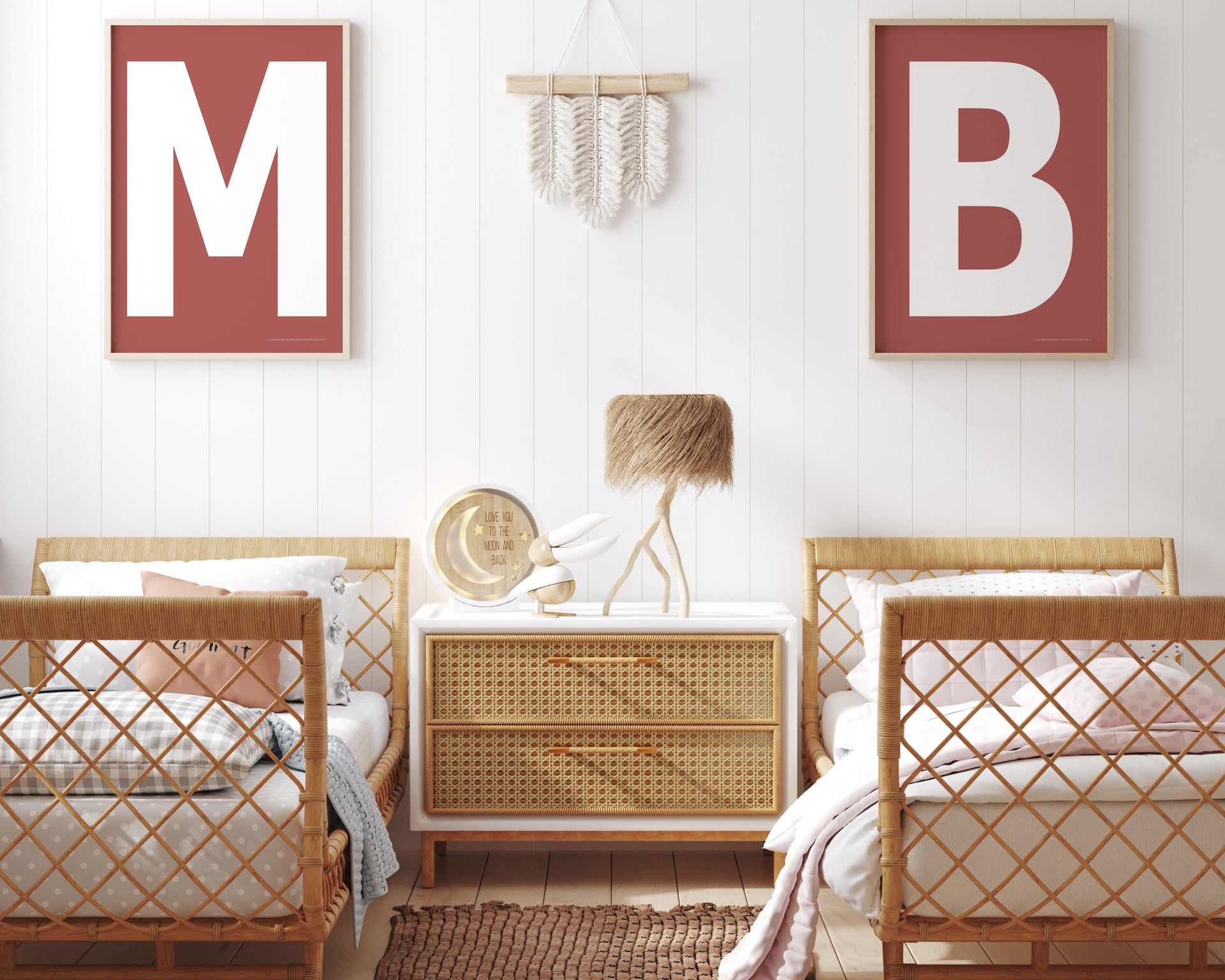 Two framed Nantucket red and white letter art prints showing initials above twin beds.