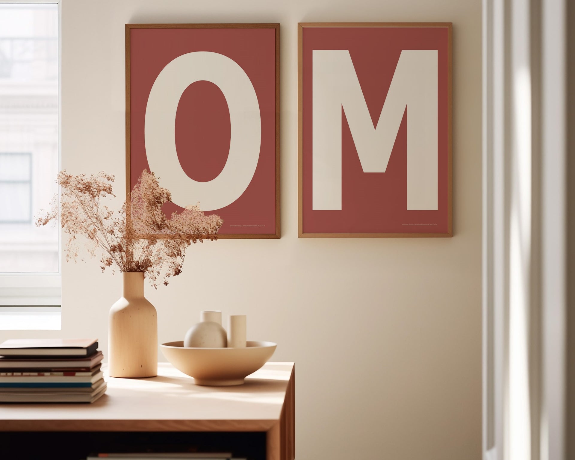 Two framed Nantucket red and white letter art prints spelling out OM in a dining room.