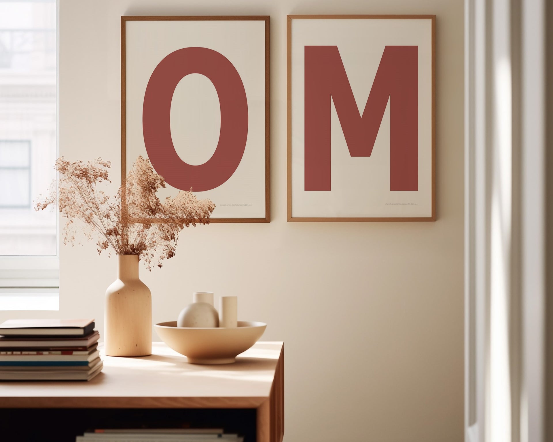 Two framed Nantucket red and white letter art prints spelling out OM in a dining room.