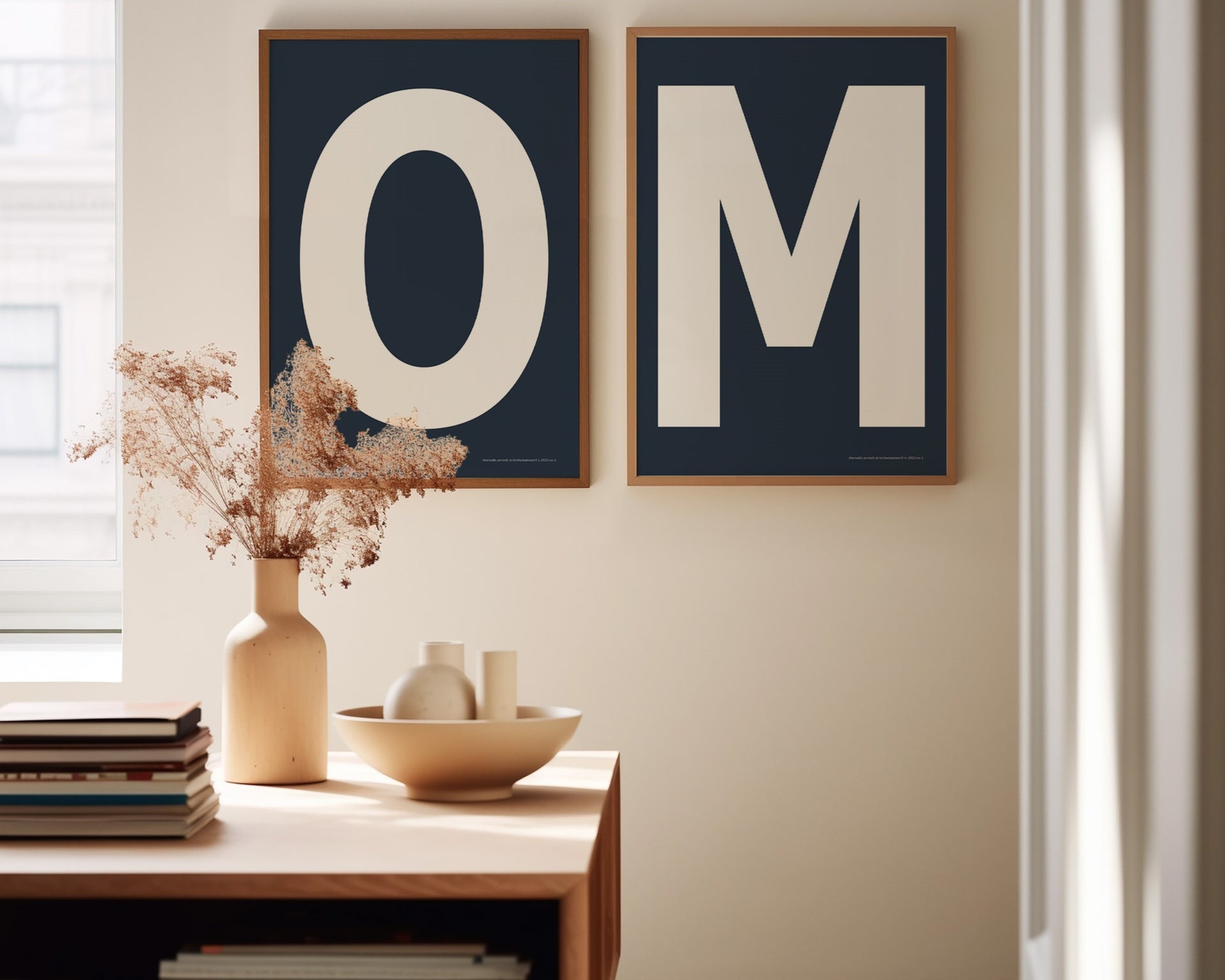 Two framed navy blue and white letter art prints spelling out OM in a dining room.