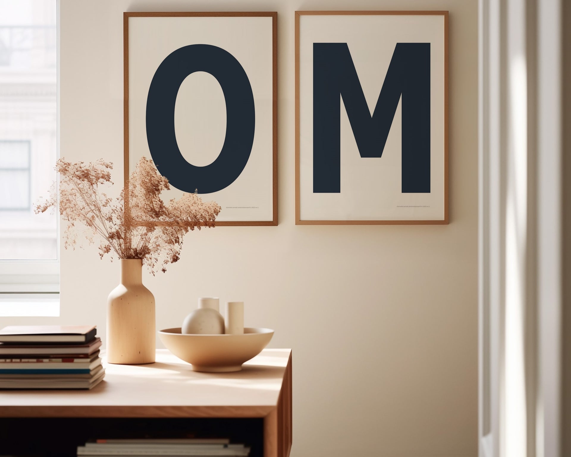 Two framed navy blue and white letter art prints spelling out OM in a dining room.