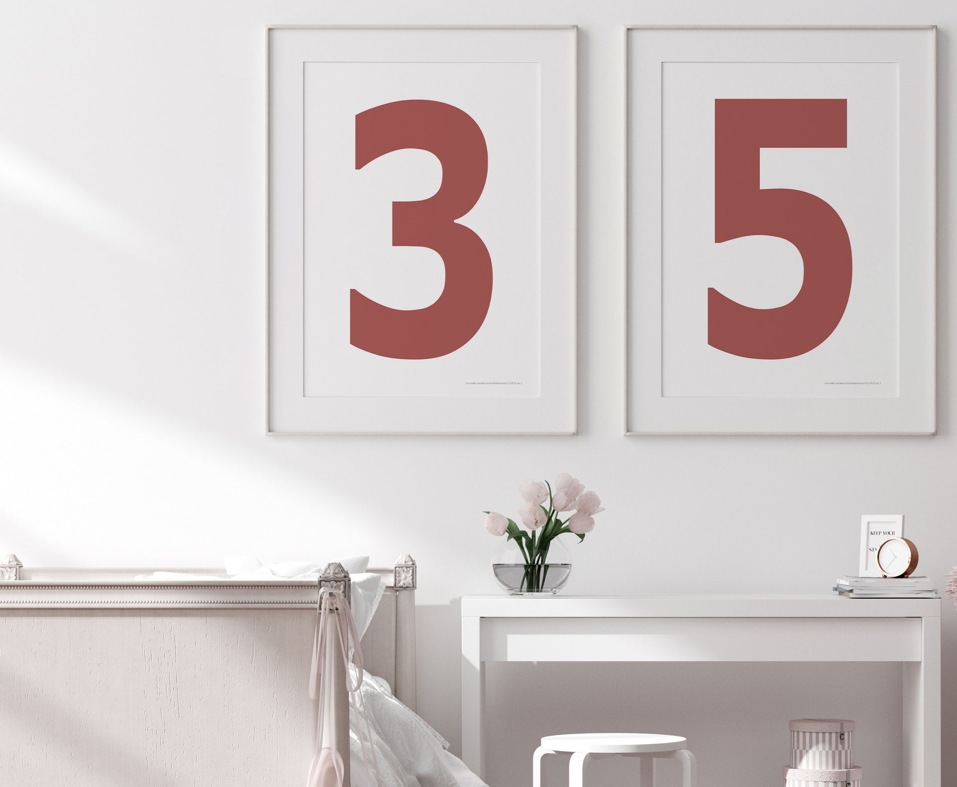 Two framed Nantucket red and white number art prints showing a jersey number hanging above bed and desk.