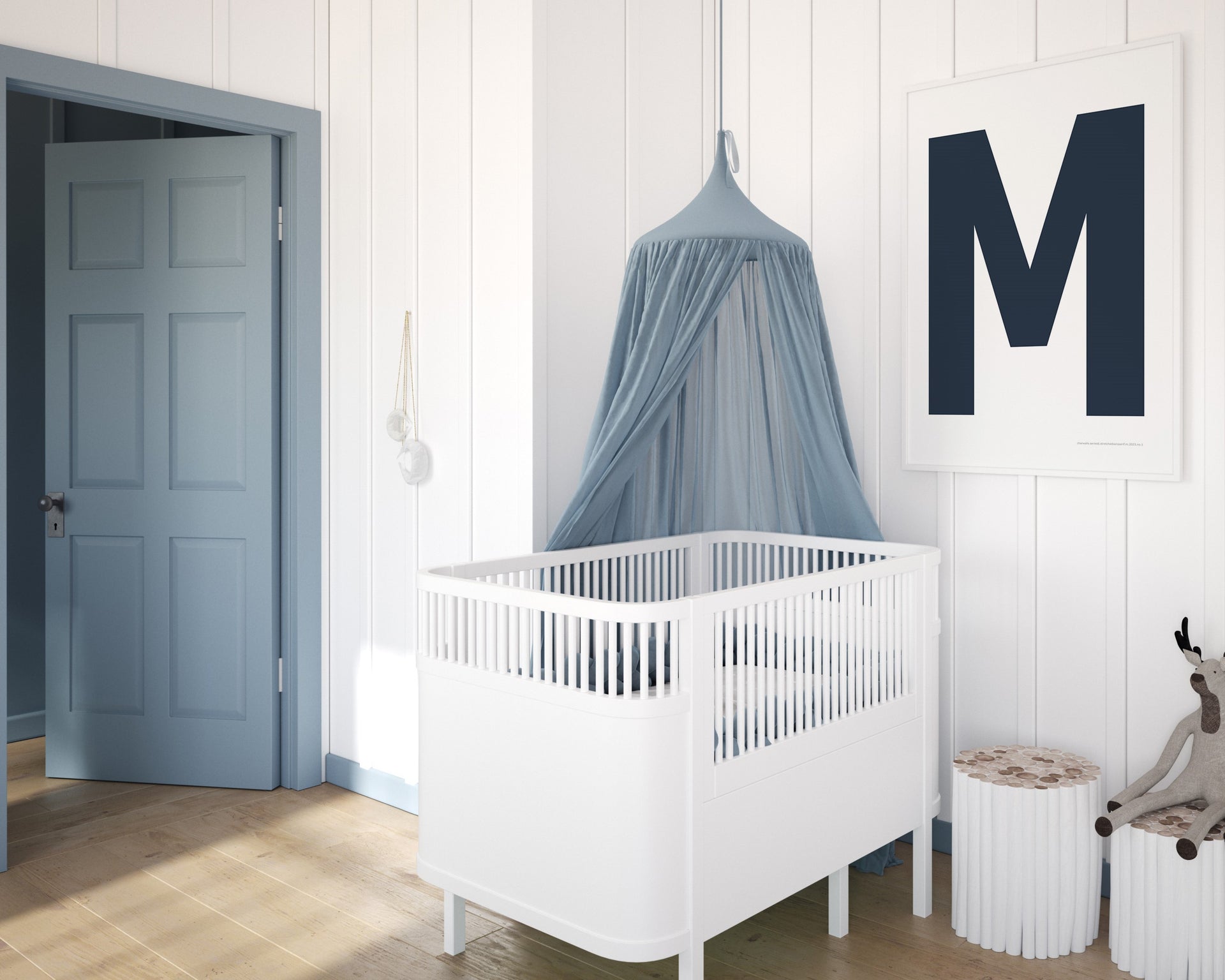 Framed navy blue and white letter art print featuring baby initial hanging over a white crib in a blue and white nursery.