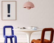 Framed navy blue and white exclamation point hanging on a wall in a modern dining room.