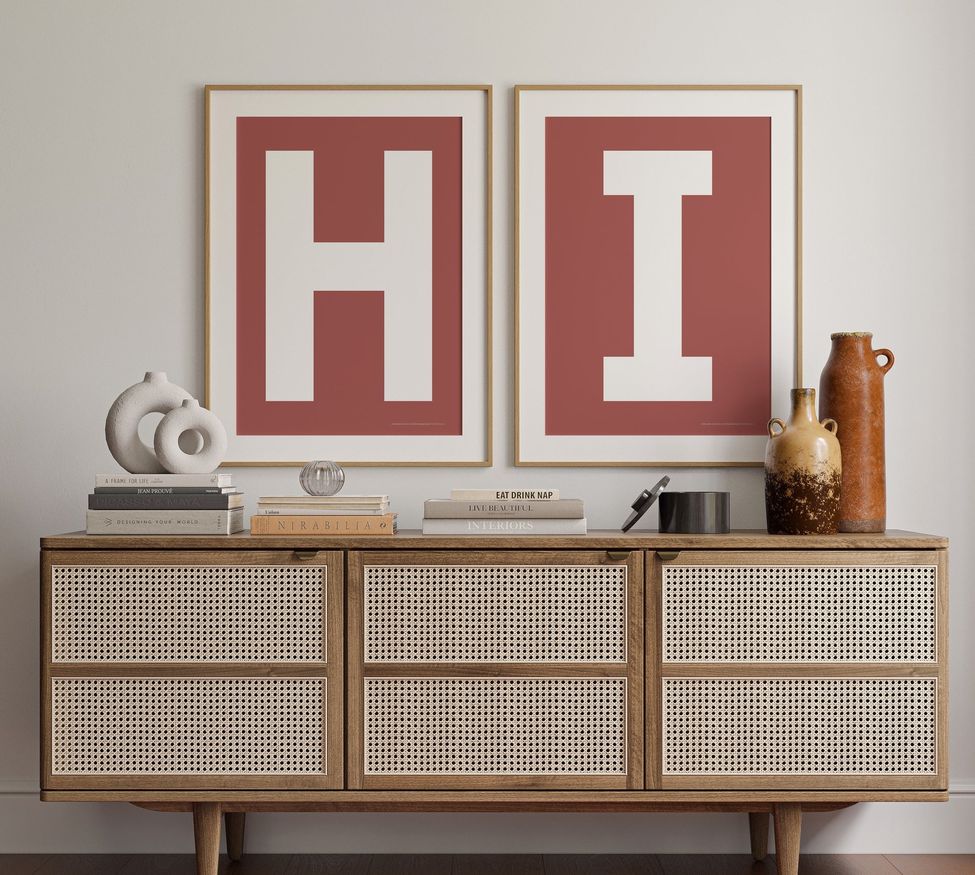 Two framed Nantucket red and white letter art prints that spell out the word HI hanging above a credenza in entryway or hallway.