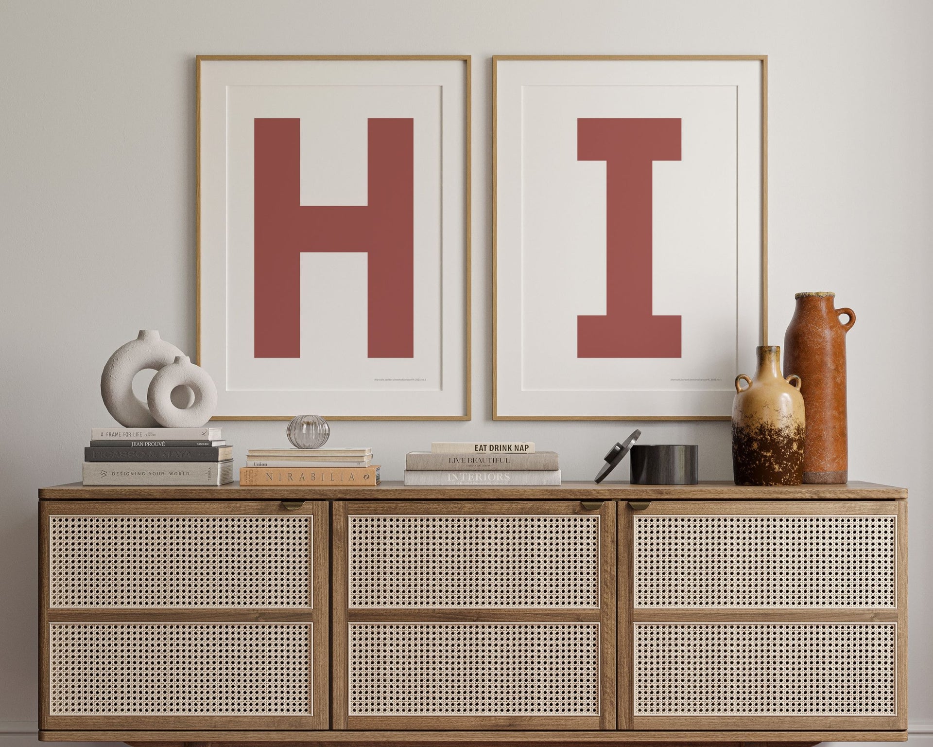 Two framed Nantucket red and white letter art prints spelling out HI hanging above a credenza in a hallway or entryway.