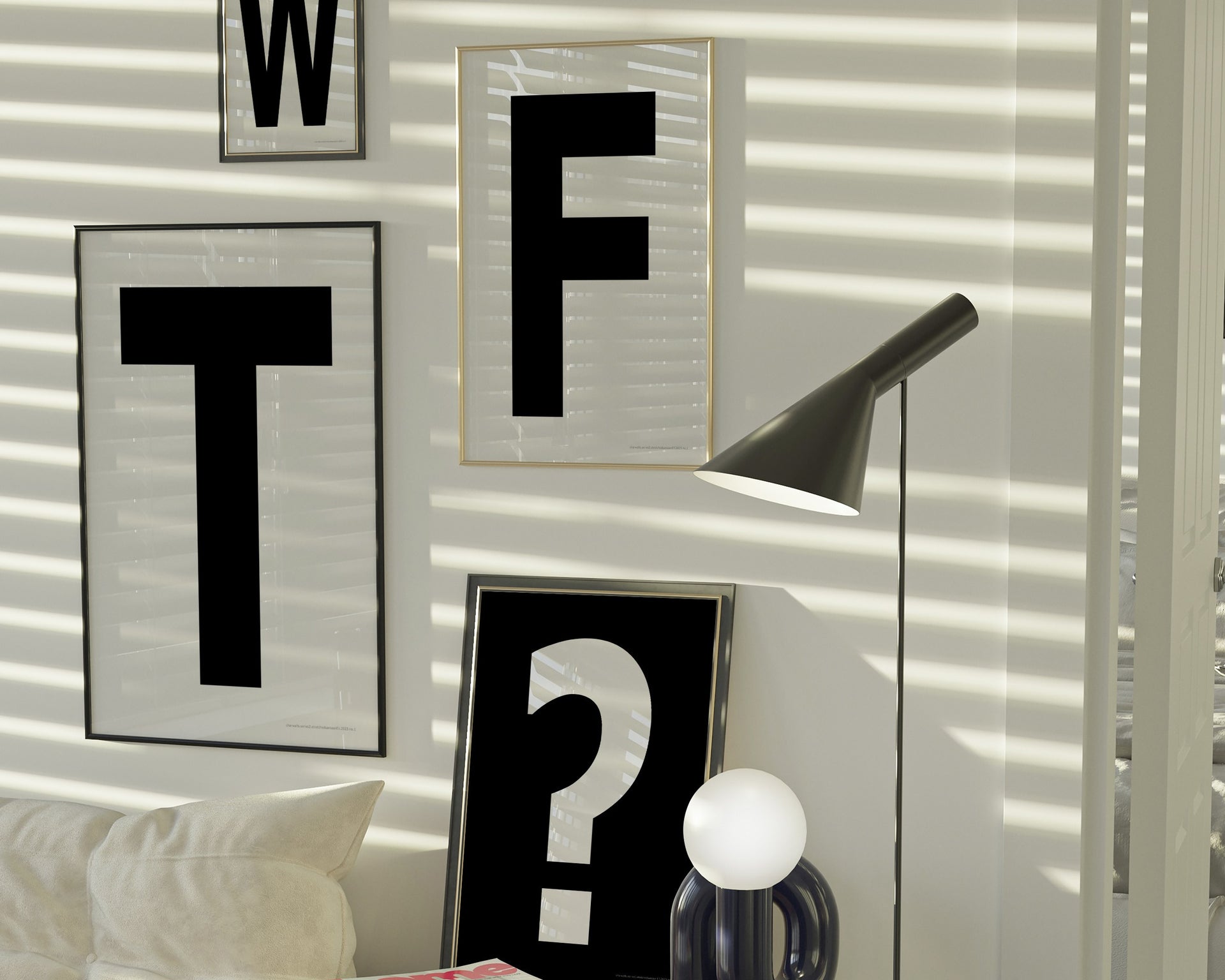 Four framed black and white letter and question mark art prints spelling out WTF? hanging on the wall in a modern living room.