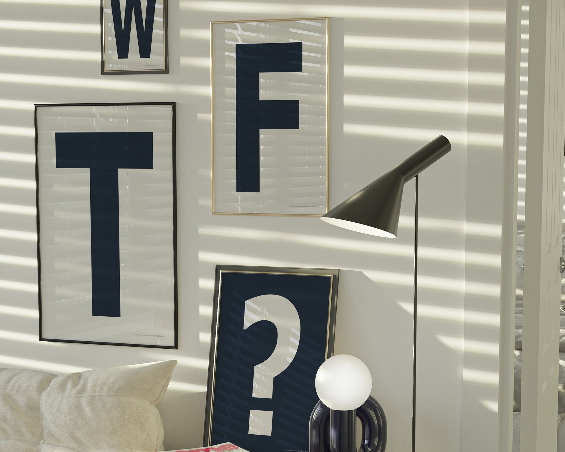 Four framed navy blue and white letter and question mark art prints spelling out WTF? hanging on the wall in a modern living room.